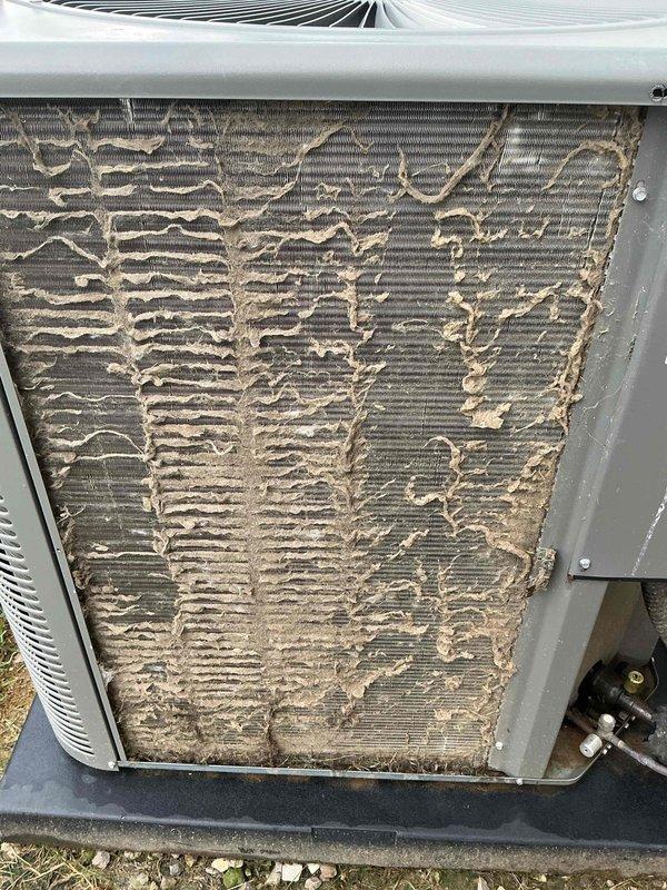 Completed annual cooling maintenance tune-up on residential HVAC system. Performed comprehensive system diagnostics using 4-port manifold gauge to verify refrigerant pressures and temperatures across all ports. Upon inspection, discovered severely deteriorated condenser coil with extensive fin damage, bent metal fins, and beige deposits coating the coil surface, significantly compromising heat transfer efficiency and system performance. Despite condenser coil degradation, system is currently operational. Documented equipment condition with photographs and provided recommendations for condenser coil replacement to restore optimal cooling capacity and energy efficiency.