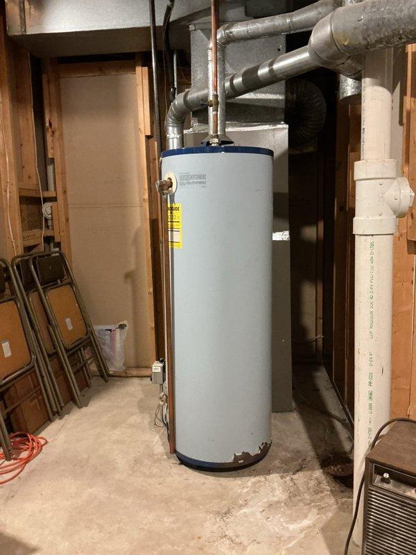 Installed a 40-gallon tall propane-fired water heater in basement utility area. Connected copper supply lines with shut-off valves, established proper venting through existing ductwork system, and verified all connections for safe operation. Unit was installed adjacent to existing HVAC system with appropriate clearances maintained per manufacturer specifications and local code requirements.