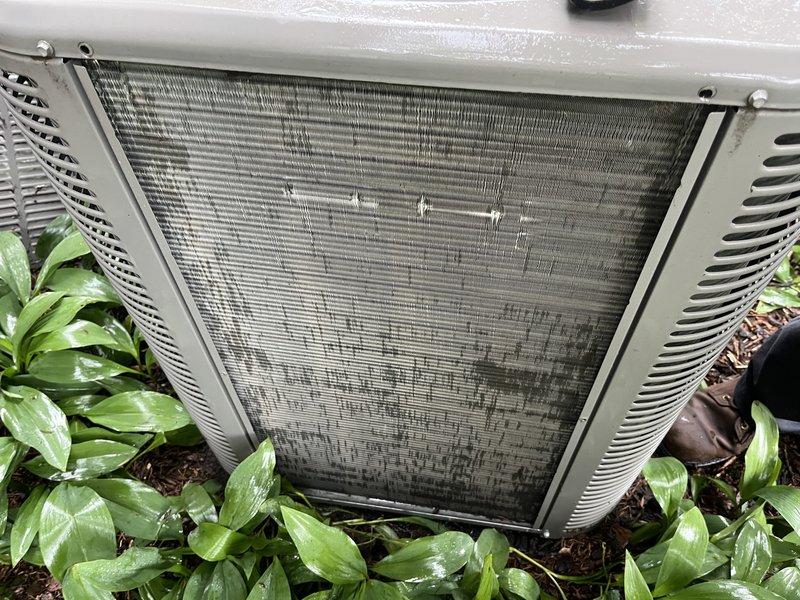 Responded to follow-up service call for frozen air conditioning system. Upon arrival, confirmed unit had thawed since previous day's visit. Performed system recharge with R-410A refrigerant to restore proper operating levels. Observed heavily soiled condenser coil with significant dirt and debris accumulation affecting heat transfer efficiency. Documented equipment condition with photographs showing contaminated outdoor coil and filter requiring future maintenance attention.