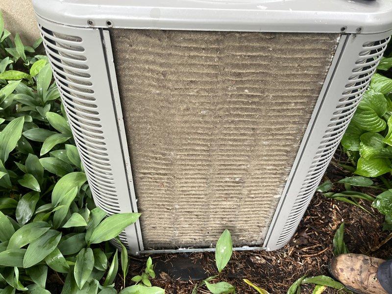 Responded to follow-up service call for frozen air conditioning system. Upon arrival, confirmed unit had thawed since previous day's visit. Performed system recharge with R-410A refrigerant to restore proper operating levels. Observed heavily soiled condenser coil with significant dirt and debris accumulation affecting heat transfer efficiency. Documented equipment condition with photographs showing contaminated outdoor coil and filter requiring future maintenance attention.