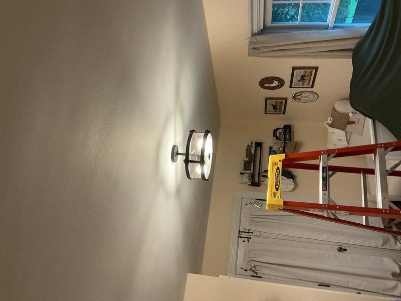 Completed installation of three ceiling fan-rated electrical boxes and wall-mounted light fixtures throughout residential hallway and adjacent room. All fixtures installed per code with proper mounting hardware, tested for operation, and confirmed illumination quality meets specification.