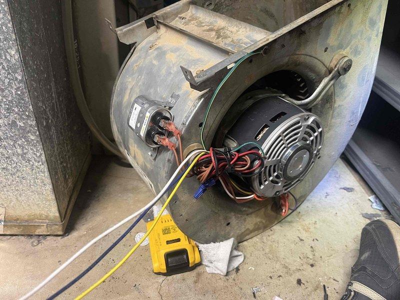 # HVAC Service - No Cool Call

Responded to no cooling complaint on 10+ year old AC unit located at side of home. Upon arrival, confirmed unit was shut down due to suspected blower motor failure. Performed diagnostic testing on blower motor assembly using multimeter to verify electrical continuity and motor functionality. Inspected blower housing, motor connections, and wiring harness for signs of failure or damage. Motor showed signs of age with significant dust accumulation on housing and internal components. Tested electrical connections at motor terminals and verified proper voltage supply to unit. Documented existing condition of blower motor assembly and electrical connections with photos for service records. Provided customer with diagnostic findings and repair recommendations to restore cooling operation.