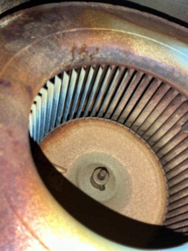Responded to no cooling complaint on 2014 system with reported frozen evaporator coil. Upon arrival, found unit powered off with fan running as instructed. Performed system diagnostics including temperature readings at supply registers and visual inspection of indoor air handler components. Inspected blower wheel assembly and verified proper operation of centrifugal fan, noting age-related patina and discoloration on housing but confirming blades remained intact and functional. Assessed airflow conditions and checked for potential restrictions that could contribute to coil freezing. Evaluated system for refrigerant leak as reported by customer and documented equipment condition with thermal imaging and component photography for service records.