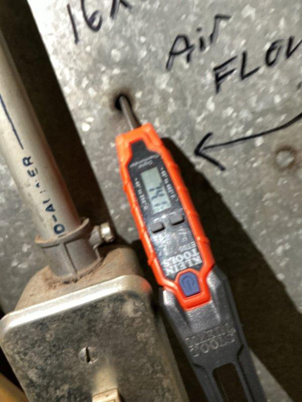 Responded to no cooling complaint on 10-year-old residential AC unit located in side yard. Upon arrival, found unit powered off with thermostat fan set to ON position. Performed comprehensive system diagnostics using digital testing meters to measure electrical parameters and refrigerant pressures at both outdoor condenser unit and indoor air handler. Identified issue preventing proper cooling operation, took diagnostic measurements of system performance, and documented findings with photos of testing equipment readings at multiple system access points. Unit required repairs to restore cooling functionality.