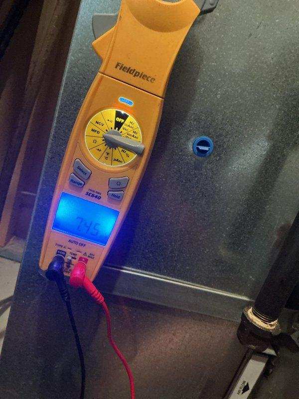 Responded to no cooling call on 10+ year old outdoor unit located on elevated platform at side of home. Upon arrival, performed electrical diagnostics using clamp meter to test voltage and amperage at the unit. Measurements indicated system was not receiving proper power or compressor was not operating within normal parameters. Documented electrical readings and equipment conditions with photos for service records.