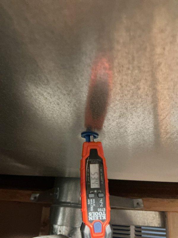 Responded to no cooling call on 10+ year old outdoor unit located on elevated platform at side of home. Upon arrival, performed electrical diagnostics using clamp meter to test voltage and amperage at the unit. Measurements indicated system was not receiving proper power or compressor was not operating within normal parameters. Documented electrical readings and equipment conditions with photos for service records.