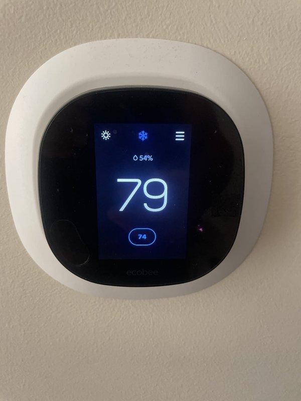 Responded to no cooling complaint on upper floor for two-unit system. Inspected outdoor condensing unit U10 and found unit operational with all electrical connections secure and compressor functioning properly. Verified thermostat display showing 79°F actual temperature with setpoint at 74°F, indicating system was running but not achieving desired cooling. Advised customer of findings and recommended system shutdown pending further diagnostics.