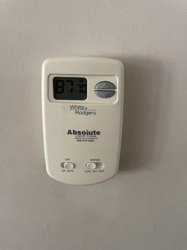 Responded to no cooling complaint on 10+ year old residential unit. Upon inspection, found outdoor unit's top filter heavily contaminated with accumulated dust, dirt, and debris causing severely restricted airflow. Indoor thermostat displayed 87°F, confirming inadequate cooling performance. Cleaned and serviced unit to restore proper operation.
