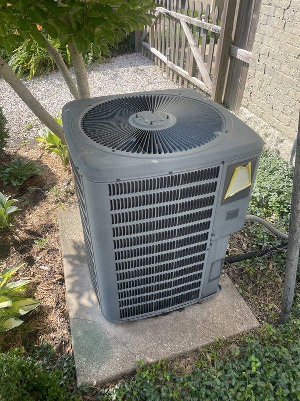 Responded to no cooling call where thermostat had already been replaced without resolving issue. Diagnosed outdoor condensing unit located on rear concrete pad behind residence with indoor equipment in cellar. Identified failed component preventing compressor operation, performed necessary repairs to restore cooling function, and verified system operation with proper temperature differential across coil.