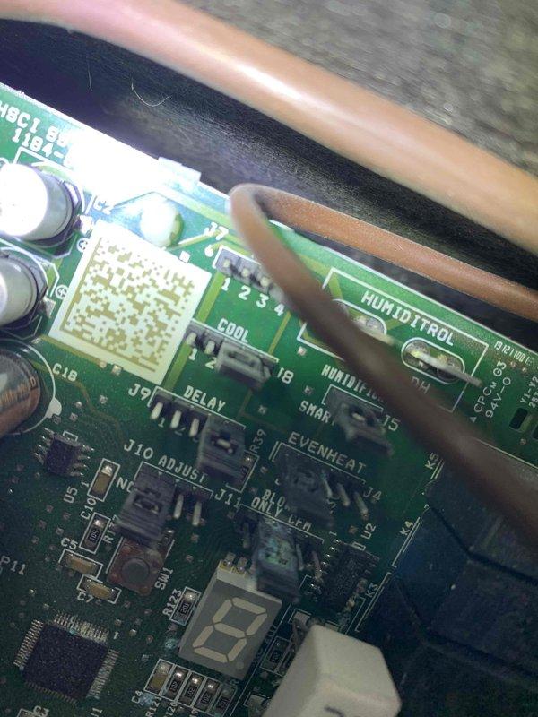 Responded to no cooling complaint on Unit 10 located in backyard near garage. Upon arrival, found system displaying motor fault message and thermostat had shut down unit. Performed diagnostic evaluation of control board and electrical components. Inspected printed circuit board, relays, capacitors, and integrated circuits for signs of failure or damage. Documented control board condition with photos showing component layout, relay modules, and connection points. Identified faulty control board as root cause of cooling failure and motor fault error. System requires control board replacement to restore proper operation and resolve no cooling condition.