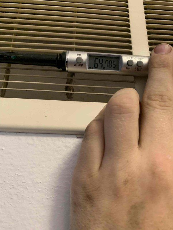 Responded to no cooling call affecting entire residence with 2021-installed AC system. Upon arrival, inspected air filter and found significant dust accumulation and debris restricting airflow through the HVAC system. Documented filter condition showing brown fibrous material with visible staining and particle buildup in mesh compartments. Measured supply air temperature at register, recording 64.7°F output. Replaced dirty air filter with new unit to restore proper airflow and system efficiency. Verified system operation and cooling performance after filter replacement. Unit now operating within normal parameters with adequate airflow restored throughout home.