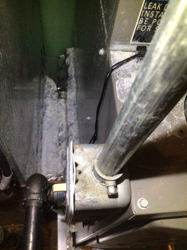 Responded to no cooling call on one-year-old Goodman air conditioning system affecting entire residence. Upon arrival, performed diagnostic evaluation of indoor and outdoor equipment. Inspected evaporator coil, condensate drain system, and ductwork installation in mechanical closet. Verified proper airflow through supply and return plenums. System components showed normal wear for age with minor dust accumulation on metal ductwork surfaces. Completed visual inspection of electrical connections, refrigerant lines, and mechanical space accessibility. Documented equipment condition with photographs for service records.