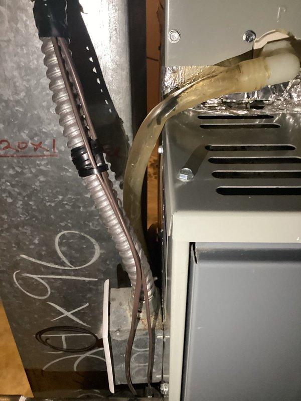Responded to service call for 13-year-old Trane air conditioning system experiencing water leakage. Upon inspection, located condensate drain line issue causing water discharge in mechanical space. Cleared obstruction from condensate drain line, verified proper drainage flow, and tested system operation to ensure no further leakage. Unit returned to normal operating condition with condensate properly draining through designated drain system.