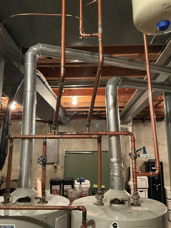 Successfully installed two 50-gallon gas tall water heaters in basement mechanical room. Connected all copper supply and discharge piping, installed proper venting through existing ductwork, and completed electrical connections for both units. Applied required plumbing identification stickers to each water heater and ensured all installations met permit requirements under permit numbers 26 PLU-13058 and 26 PLU-13059.