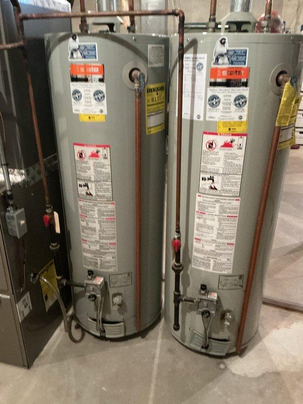 Successfully installed two 50-gallon gas tall water heaters in basement mechanical room. Connected all copper supply and discharge piping, installed proper venting through existing ductwork, and completed electrical connections for both units. Applied required plumbing identification stickers to each water heater and ensured all installations met permit requirements under permit numbers 26 PLU-13058 and 26 PLU-13059.