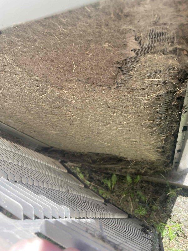# HVAC Tune-Up Completed

Performed preventive maintenance tune-up on a 15-year-old Lennox XC14 outdoor condensing unit located at side of property. Unit exhibited significant debris accumulation including dust, lint, and fibrous material buildup on condenser coil fins, along with vegetation growth at base. Cleaned condenser coil to remove heavy layer of accumulated debris, cleared vegetation from around unit perimeter, and completed standard tune-up procedures including electrical component inspection, refrigerant level verification, and operational testing. Unit restored to proper operating condition with improved airflow through coil assembly. Documented equipment condition with photos showing before condition and manufacturer specification label (Model XC14-030-230-01, Serial 5808D23430).