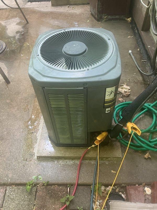 Responded to no cooling complaint on single air conditioning unit located at ground level behind residence. Upon arrival, found system had experienced evaporator coil freeze-up requiring manual defrost before service could be performed. Connected refrigerant gauges to condenser unit to diagnose cooling issue and verify system pressures after coil thawing was complete.