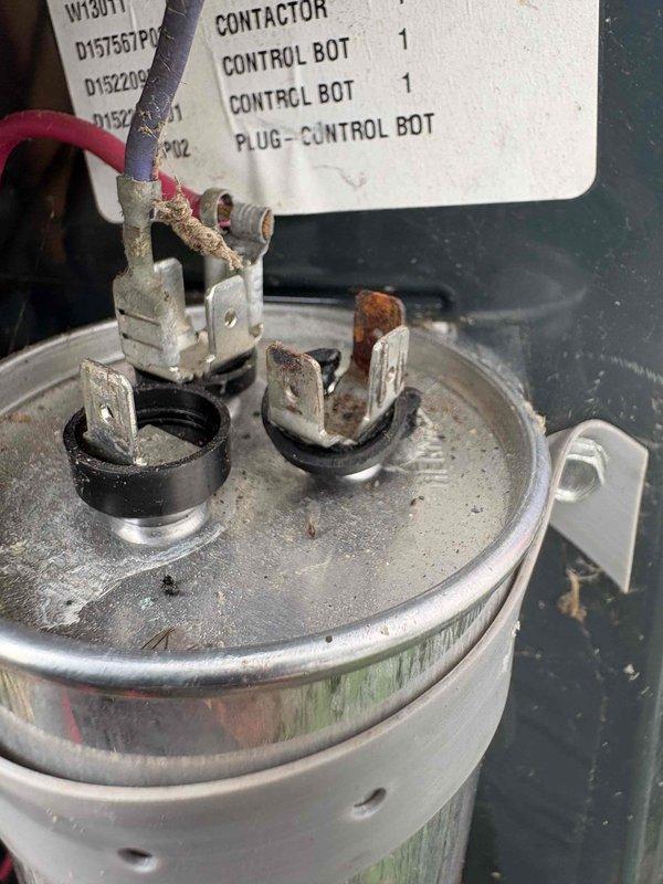 Responded to callback for cooling system not maintaining set temperature on 10+ year old unit located in side yard. Upon inspection, found heavily corroded capacitor terminal with significant rust buildup and oxidation, compromising electrical connection and system performance. Replaced failed capacitor and verified proper electrical connections. System tested and confirmed cooling to setpoint with normal amperage draw and temperature differential across coil.