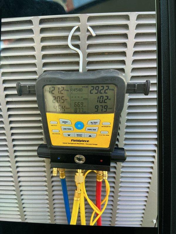 Responded to callback for new system installation (less than 1 year old) reporting frozen evaporator coil. Upon arrival, connected manifold gauges to assess refrigerant charge and system pressures, revealing readings of 121.2 PSI suction, 292.2 PSI discharge with R-454B refrigerant, superheat at 7.0°F, and subcooling at 10.2°F. Inspected Durozone SMZ-SW zone control board for potential airflow restrictions or damper issues that could cause freezing. Advised unit to remain off until system thaws completely. Documented system pressures and zone control configuration with photos for follow-up diagnosis of low airflow or refrigerant charge concerns causing coil freeze-up on newly installed equipment.