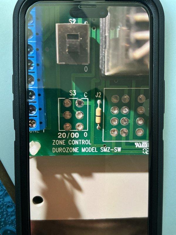 Responded to callback for new system installation (less than 1 year old) reporting frozen evaporator coil. Upon arrival, connected manifold gauges to assess refrigerant charge and system pressures, revealing readings of 121.2 PSI suction, 292.2 PSI discharge with R-454B refrigerant, superheat at 7.0°F, and subcooling at 10.2°F. Inspected Durozone SMZ-SW zone control board for potential airflow restrictions or damper issues that could cause freezing. Advised unit to remain off until system thaws completely. Documented system pressures and zone control configuration with photos for follow-up diagnosis of low airflow or refrigerant charge concerns causing coil freeze-up on newly installed equipment.