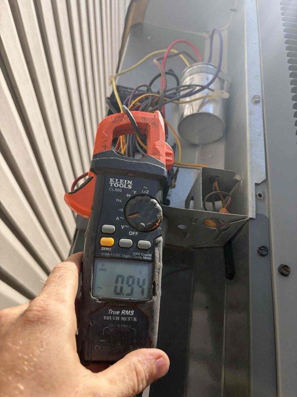 Responded to no cooling complaint on 11-year-old residential air conditioning system. Upon arrival, performed comprehensive diagnostic evaluation using refrigerant manifold gauges to measure system pressures and temperatures across suction and liquid lines. Electrical testing conducted with clamp meter revealed low amperage draw of 0.94 amps at outdoor unit, indicating compressor failure to operate under load. Inspected electrical panel components including capacitor and control wiring. System was non-operational due to compressor malfunction. Customer advised unit requires compressor replacement or full system replacement given age of equipment and advised to keep system off to prevent further damage.