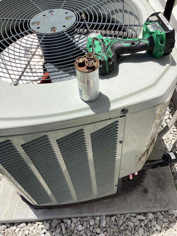 Responded to no cooling complaint on ground-level condenser unit. Upon inspection, identified failed dual-run capacitor preventing compressor operation. Replaced defective capacitor with new unit and restored system to normal operation. Advised to shut AC off temporarily and run fan only until repair was completed to prevent further strain on system components.