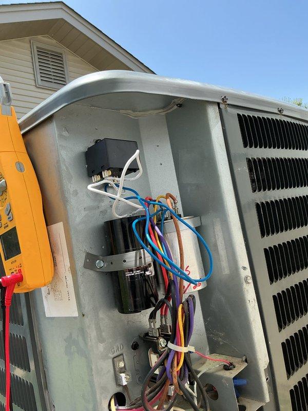 Replaced failed hard start kit and capacitor on outdoor air conditioning unit. Removed corroded components from electrical compartment, installed new parts from truck stock, and verified proper system operation. Unit tested and confirmed cooling functionality upon completion.