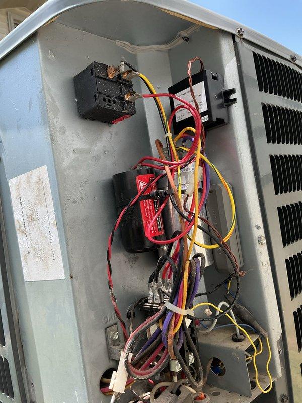 Replaced failed hard start kit and capacitor on outdoor air conditioning unit. Removed corroded components from electrical compartment, installed new parts from truck stock, and verified proper system operation. Unit tested and confirmed cooling functionality upon completion.