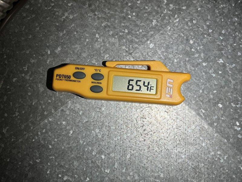Responded to no cooling complaint on 10+ year old unit located at ground level. Performed diagnostic temperature measurements using digital thermometer, recording supply air temperature of 73.5°F and abnormally high discharge line temperature of 654°F, indicating potential compressor failure or refrigerant system issue. Advised customer to shut off AC system immediately to prevent further damage and keep fan running for air circulation until repairs can be completed.