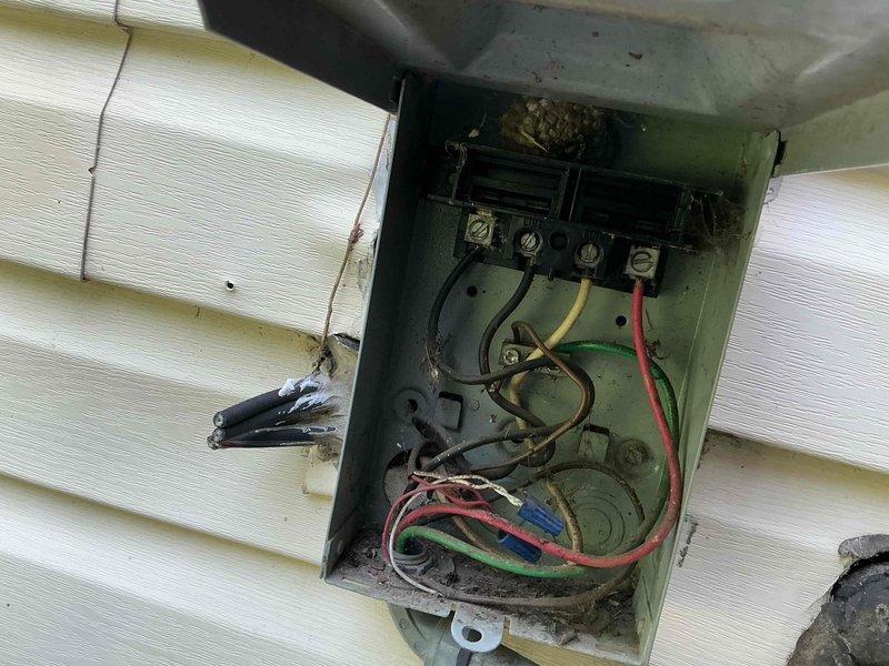 Responded to no cooling call for one-year-old AC system affecting entire home. Upon arrival, performed electrical system inspection at both outdoor disconnect panel and interior breaker panel. Outdoor service disconnect showed signs of weathering, corrosion, and deteriorated connections with visible wire damage at terminal points. Interior breaker panel inspection revealed tripped circuit breakers serving the HVAC system. Reset affected breakers and verified proper electrical supply to condensing unit. Documented electrical panel conditions with photographic evidence showing corroded connections at outdoor disconnect and tripped breakers at main panel. Restored power to AC system and verified unit operation. Recommended monitoring system performance and addressing corroded outdoor electrical connections to prevent future service interruptions.