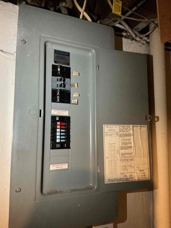 Responded to no cooling call for one-year-old AC system affecting entire home. Upon arrival, performed electrical system inspection at both outdoor disconnect panel and interior breaker panel. Outdoor service disconnect showed signs of weathering, corrosion, and deteriorated connections with visible wire damage at terminal points. Interior breaker panel inspection revealed tripped circuit breakers serving the HVAC system. Reset affected breakers and verified proper electrical supply to condensing unit. Documented electrical panel conditions with photographic evidence showing corroded connections at outdoor disconnect and tripped breakers at main panel. Restored power to AC system and verified unit operation. Recommended monitoring system performance and addressing corroded outdoor electrical connections to prevent future service interruptions.