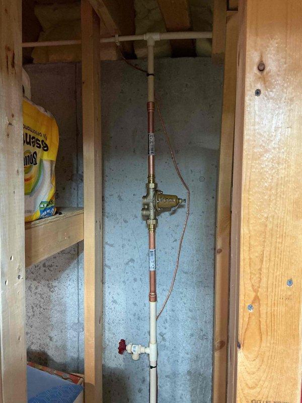 Installed 50-gallon gas tall water heater in basement utility area with copper supply line connections and CPVC integration using 3/4" CPVC to copper bell adapters. Replaced supply line to master bedroom upstairs on time and material basis. CPVC piping requires cutting back before hangers for proper support and clearance. No flue installation required for this unit configuration.