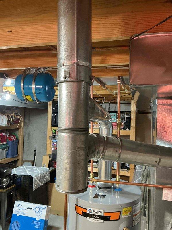 Installed 50-gallon gas tall water heater in basement utility area with copper supply line connections and CPVC integration using 3/4" CPVC to copper bell adapters. Replaced supply line to master bedroom upstairs on time and material basis. CPVC piping requires cutting back before hangers for proper support and clearance. No flue installation required for this unit configuration.