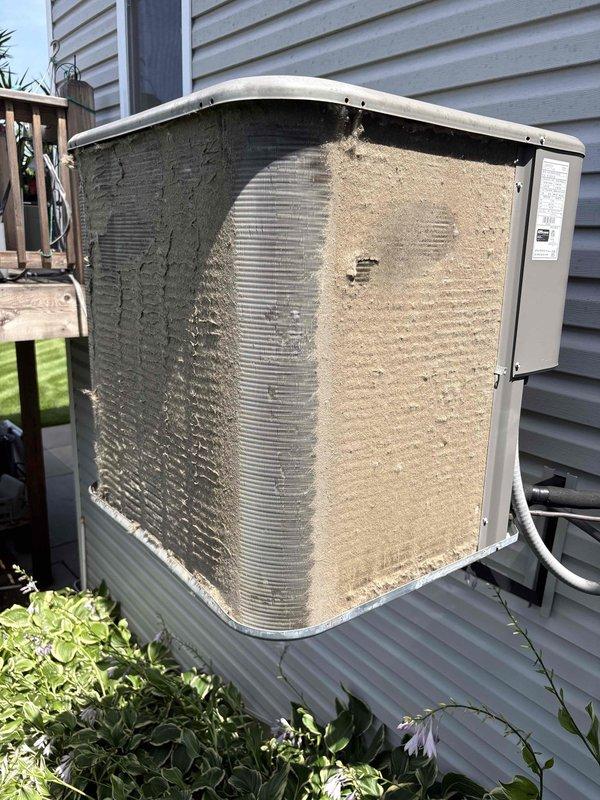 Responded to no cooling complaint on residential air conditioning system. Upon arrival, found outdoor condenser unit heavily soiled with dirt, dust, and debris accumulation significantly restricting airflow through coil surfaces. Performed thorough cleaning of condenser coil and exterior cabinet to restore proper airflow and heat transfer efficiency. System operational following service with adequate cooling capacity restored.