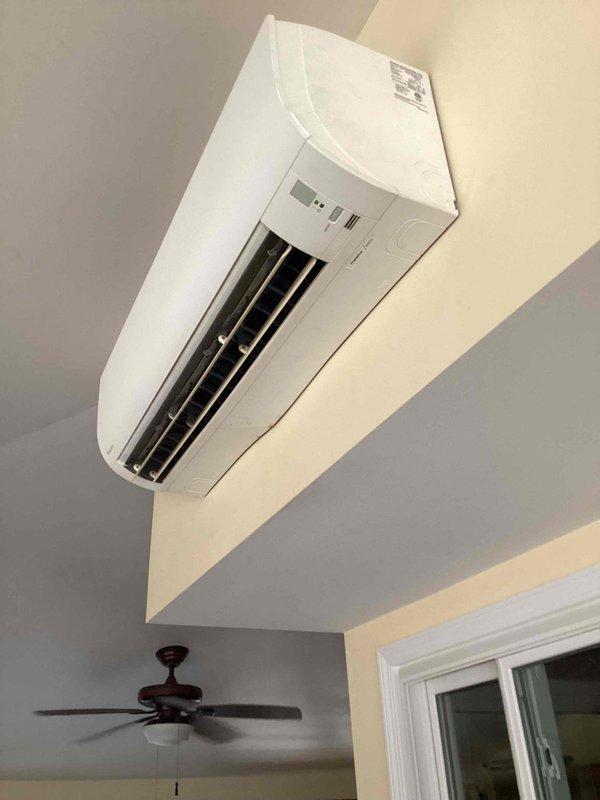 Responded to no cooling complaint on 11-year-old ductless mini-split system. Upon arrival, confirmed unit was running but delivering warm air instead of conditioned air. Performed diagnostic evaluation of wall-mounted indoor air handler and identified refrigerant system issue preventing proper cooling operation. Given the age of the equipment and ongoing nature of the cooling problem, recommended system replacement for long-term reliability. Documented equipment condition with photos showing wall-mounted evaporator unit installation and surrounding area. Customer advised of findings and repair options.