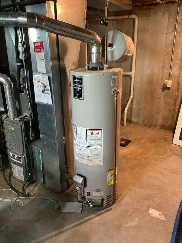 Responded to no hot water condition in basement utility area. Successfully removed existing 50-gallon gas water heater, exercising extreme caution during removal of full 5-gallon expansion tank to prevent damage to CPVC supply lines. Installed new standard 50-gallon tall gas water heater with all standard connections and components. Connected 4-inch flue pipe to existing vent system. Tested unit operation, verified proper gas combustion, checked all water connections for leaks, and confirmed hot water delivery throughout residence. Unit operational and performing to manufacturer specifications.