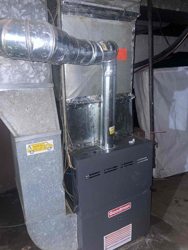 Responded to service call for air conditioning unit cycling on and off intermittently. Inspected Goodman HVAC system located in basement utility area, including furnace, air handler, and associated ductwork. Evaluated electrical connections and wiring at equipment, noting disorganized wiring configuration with multiple conductors including ground wire. Examined system components for potential causes of short cycling including thermostat communication, electrical connections, and control board functionality. Photographed installation for service records. System evaluated and customer advised of findings.