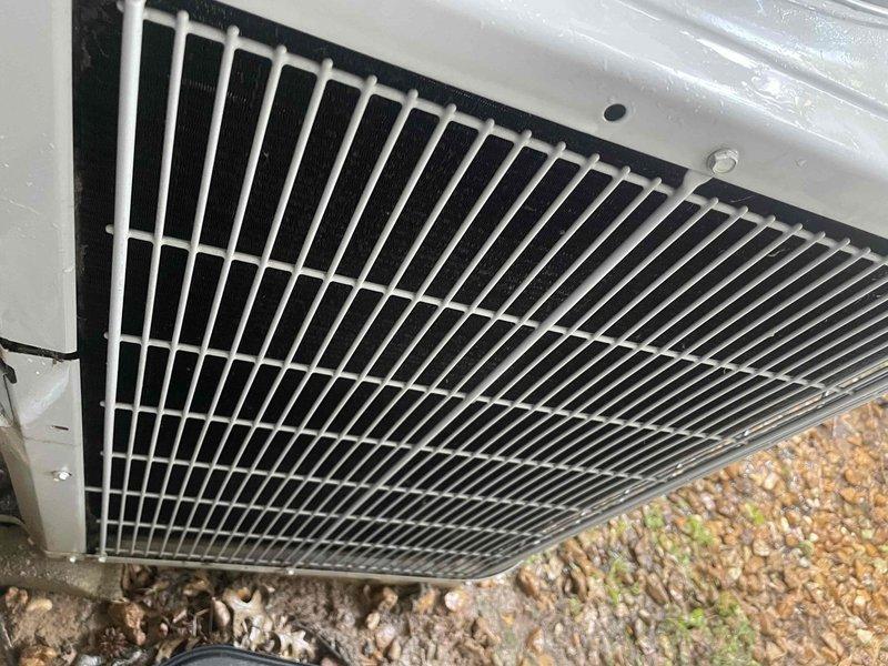 Responded to no cooling call on 10+ year old outdoor unit located at rear of property. Upon arrival, performed system diagnostic and found electrical disconnect panel with deteriorated wiring connections and aged insulation showing signs of environmental exposure. Inspected outdoor condensing unit with white metal housing and top discharge grille. Identified compromised electrical connections as primary cause of system failure. Advised customer of findings and recommended electrical repairs to restore proper system operation and ensure safe functionality.