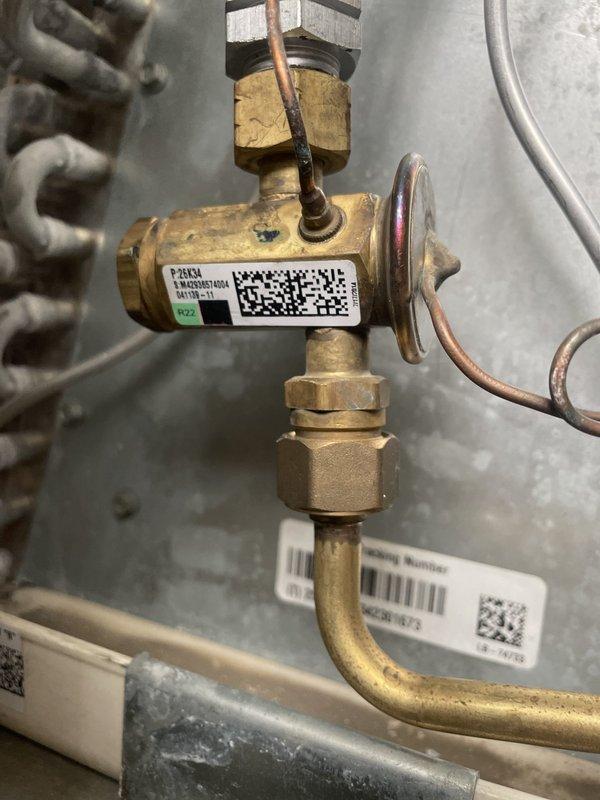 Responded to recall for AC unit not cooling with frozen evaporator coil on 9-month-old system. Upon inspection, verified proper operation of TXV valve and confirmed refrigerant metering components functioning correctly. System tested and operating within normal parameters with no refrigerant leaks detected.