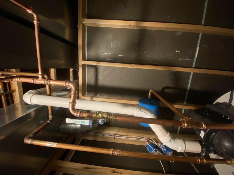 Removed and drained the existing tall water heater from the mechanical room. Capped the 1/2" copper gas line and 4" flue tee that serviced the removed unit. Repiped the cold water supply to the remaining 50-gallon power vent water heater, converting it to serve as the sole water heating system for the residence. Installed a new two-gallon expansion tank on the cold water line. Coordinated careful removal of the old water heater to avoid disturbing the existing power vent gas controls and surrounding plumbing infrastructure. Completed all necessary copper piping connections and verified proper water flow to the remaining unit. Cleaned the work area and hauled away the old water heater and all related debris.
