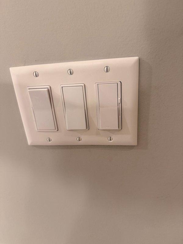 Responded to service call for non-functioning three-way light switch in master bathroom. Diagnosed electrical issue with three-gang switch configuration controlling recessed ceiling lighting fixtures. Troubleshot wiring connections, identified faulty switch mechanism, and restored proper operation to the three-way switching system controlling five recessed can lights installed in the angled ceiling.