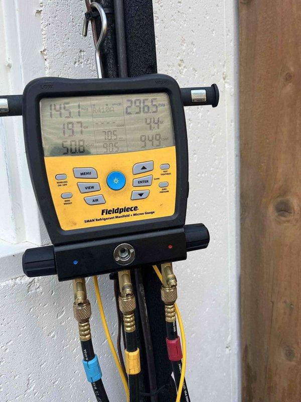 Responded to service call for 10-year-old residential air conditioning unit not maintaining desired temperature. Upon arrival, performed comprehensive system diagnostics using refrigerant manifold gauges and micron gauge to assess operating pressures, temperatures, and superheat/subcooling values. Measurements indicated system was operating outside normal parameters. Inspected condensing unit components including refrigerant lines, electrical connections, and service valves at outdoor unit location. Evaluated copper line set insulation, brass service ports, and PVC condensate drainage system for proper installation and function. Documented system readings and component conditions with photographic evidence for service records. Identified performance issues requiring further repair recommendations to restore unit to proper cooling capacity.