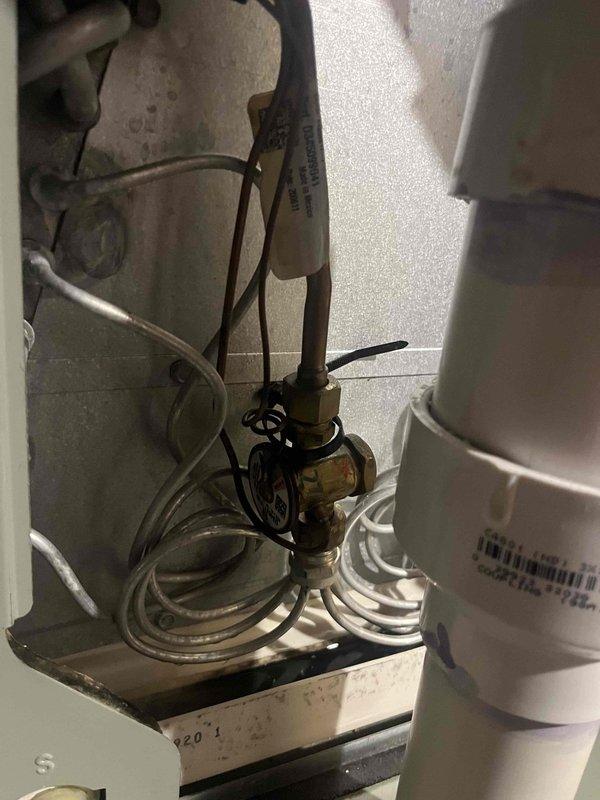Responded to service call for 10-year-old residential air conditioning unit not maintaining desired temperature. Upon arrival, performed comprehensive system diagnostics using refrigerant manifold gauges and micron gauge to assess operating pressures, temperatures, and superheat/subcooling values. Measurements indicated system was operating outside normal parameters. Inspected condensing unit components including refrigerant lines, electrical connections, and service valves at outdoor unit location. Evaluated copper line set insulation, brass service ports, and PVC condensate drainage system for proper installation and function. Documented system readings and component conditions with photographic evidence for service records. Identified performance issues requiring further repair recommendations to restore unit to proper cooling capacity.