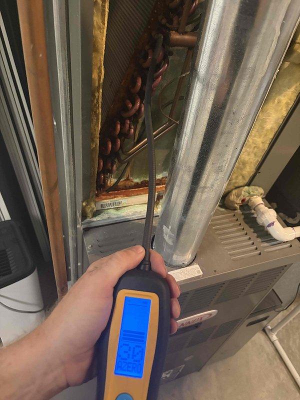 Responded to no cooling complaint on 18-year-old system located in basement. Unit was running continuously but failing to reach setpoint temperature. Performed diagnostic evaluation using digital manifold gauges and temperature measurement tools at the evaporator coil and condensing unit. Measured system pressures and temperatures, recording suction temperature of 133.9°F and discharge temperature of 341.4°F with corresponding pressure readings. Found system operating with abnormal superheat and subcooling values indicating potential refrigerant charge issues or restriction in refrigeration circuit. Inspected evaporator coil assembly and confirmed airflow across coil. Evaluated outdoor condensing unit performance and verified compressor operation. Provided customer with findings and repair options to restore proper cooling operation.
