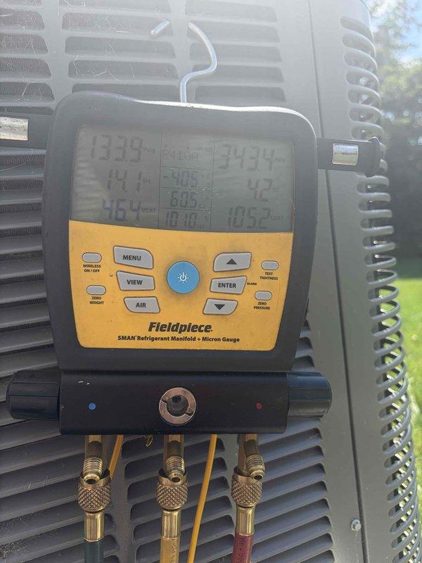 Responded to no cooling complaint on 18-year-old system located in basement. Unit was running continuously but failing to reach setpoint temperature. Performed diagnostic evaluation using digital manifold gauges and temperature measurement tools at the evaporator coil and condensing unit. Measured system pressures and temperatures, recording suction temperature of 133.9°F and discharge temperature of 341.4°F with corresponding pressure readings. Found system operating with abnormal superheat and subcooling values indicating potential refrigerant charge issues or restriction in refrigeration circuit. Inspected evaporator coil assembly and confirmed airflow across coil. Evaluated outdoor condensing unit performance and verified compressor operation. Provided customer with findings and repair options to restore proper cooling operation.