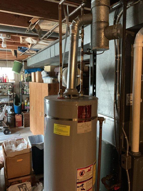Replaced leaking 40-gallon gas water heater in basement with new unit. Installation included connecting copper supply lines, gas line, and installing 3/4" pressure reducing valve. Applied required plumbing identification sticker and ensured all connections met code requirements per permit specifications. Unit tested and operational upon completion.