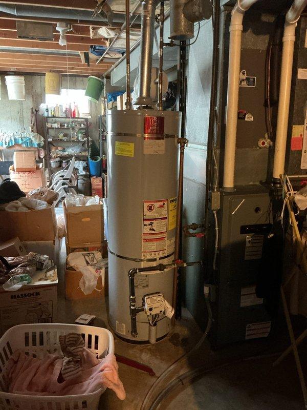 Replaced leaking 40-gallon gas water heater in basement with new unit. Installation included connecting copper supply lines, gas line, and installing 3/4" pressure reducing valve. Applied required plumbing identification sticker and ensured all connections met code requirements per permit specifications. Unit tested and operational upon completion.