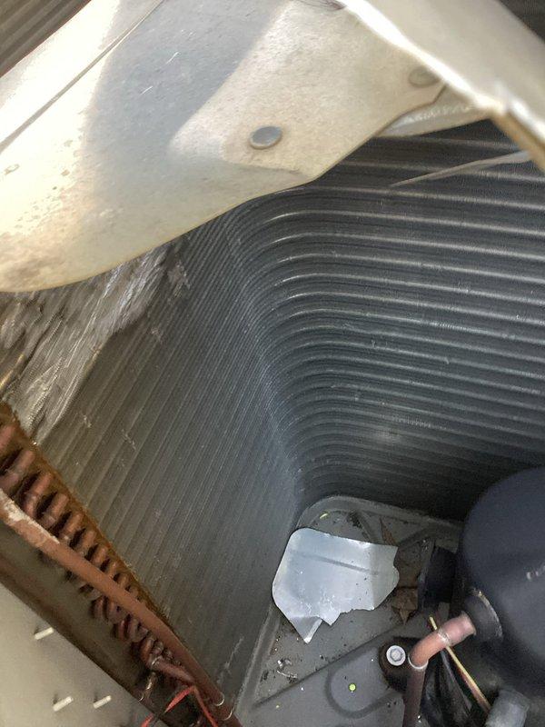 Responded to no-cool complaint on 10+ year old outdoor unit located in backyard. Upon arrival, found fan blade had catastrophically failed, breaking off and striking condenser coil on all four sides causing significant impact damage. Performed thorough inspection of condenser coil for refrigerant leaks using leak detection methods and pressure testing. Assessed internal components including evaporator coil assembly and refrigerant lines for secondary damage. Documented extensive damage to unit housing, condenser fins, and mounting brackets with photographic evidence. Contacted customer to discuss findings regarding system repairability versus replacement options given age of equipment and extent of damage. Unit remains non-operational pending customer decision on repair authorization.