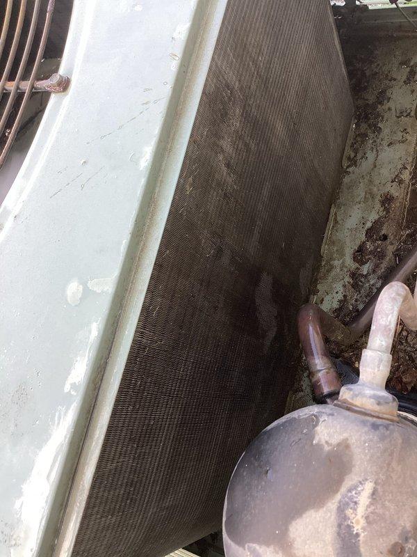 Responded to no cooling complaint on 10+ year old unit located in side yard. Upon arrival, found condenser coil heavily soiled with dirt and debris accumulation, significantly restricting airflow and reducing heat transfer efficiency. Performed thorough coil cleaning to restore proper airflow and system capacity. Unit tested after service and confirmed cooling operation restored to normal parameters.