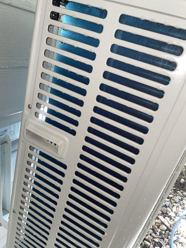 Responded to no cooling complaint on 1-year-old ductless mini-split system located in sunroom. Upon inspection, found indoor wall-mounted air handler and outdoor condensing unit both operational but system not achieving desired temperature. Verified refrigerant charge, cleaned outdoor coil fins which showed minor debris accumulation, and confirmed proper airflow from indoor unit. System restored to normal cooling operation and tested successfully before departure.
